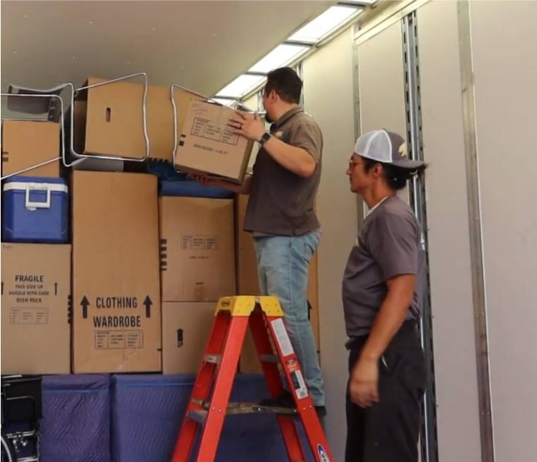 Professional movers loading a truck near a Visalia neighborhood providing secure storage near me in Visalia.