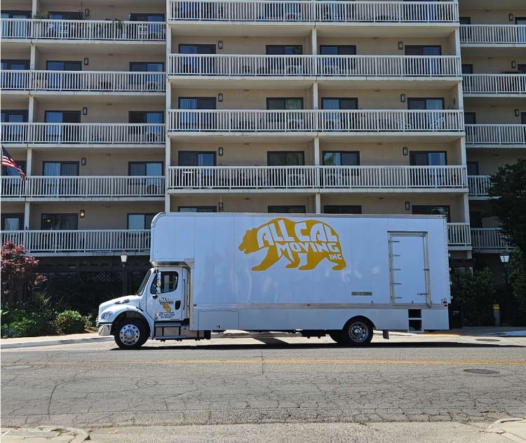 all cal moving truck in frnot of an apartments building