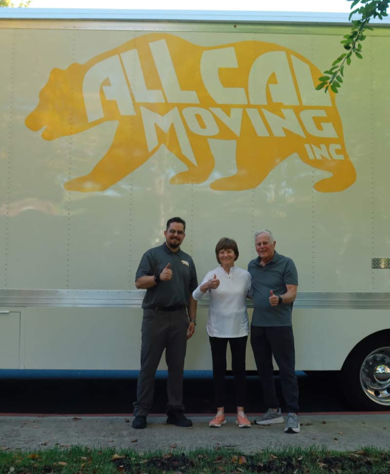All Cal Moving team member and a happy senior couple giving thumbs up in front of the truck, representing trusted and stress-free senior moving in Tulare County